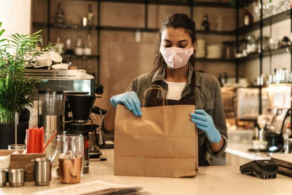 Woman with face mask standing at the counter
